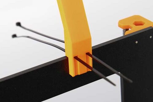 Holding the assembled filament guide on the crossbeam of the 3D printer