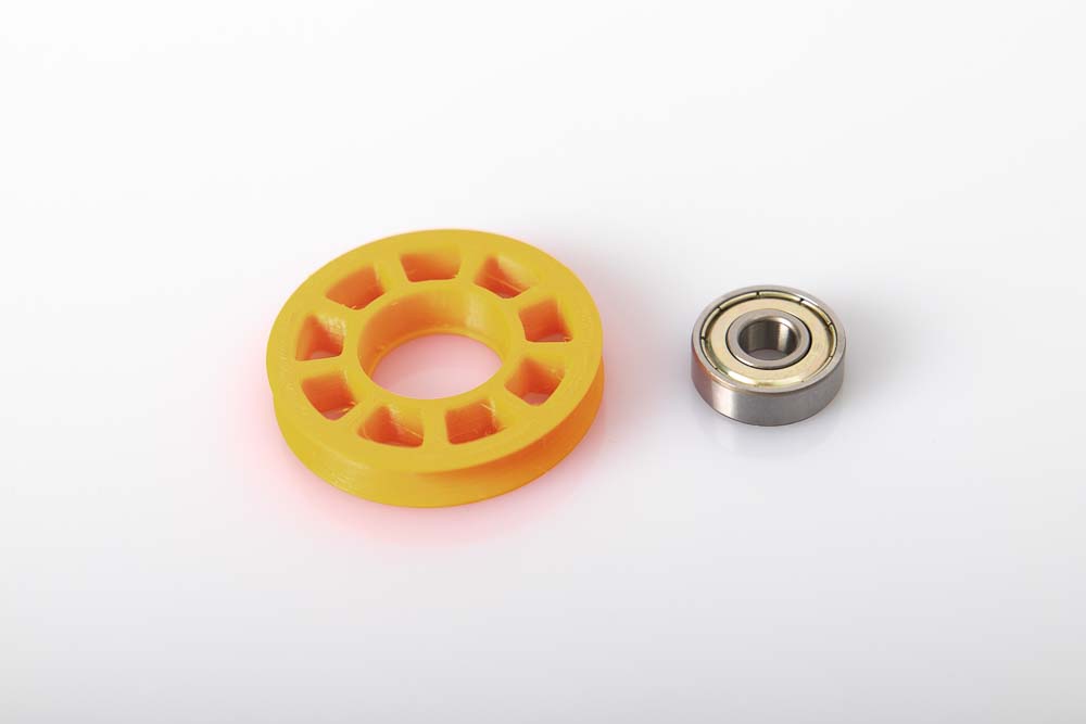 3D printed pulley and the ball bearing are next to each other