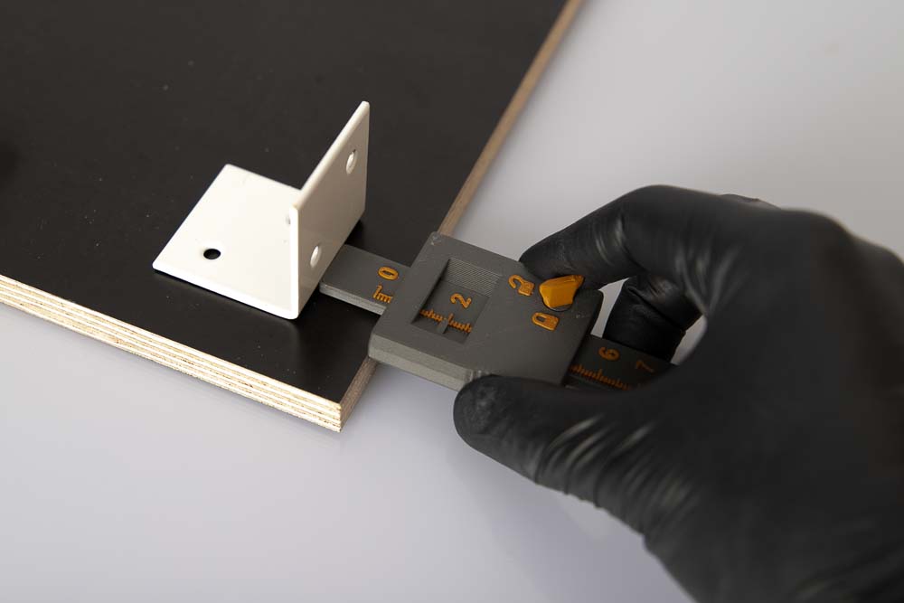 Positioning of a steel bracket on a wooden board with the 3D printed depth caliper