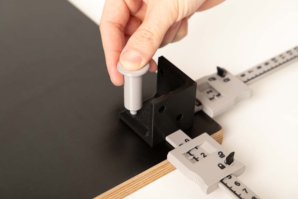 Dreiseitiger 3D Druck Winkel auf Holzplatte Unten wird mittels 2 Tiefenmessschiebern positioniert und mit dem 3D Druck Markierer durch die Bohrungen am Holz markiert