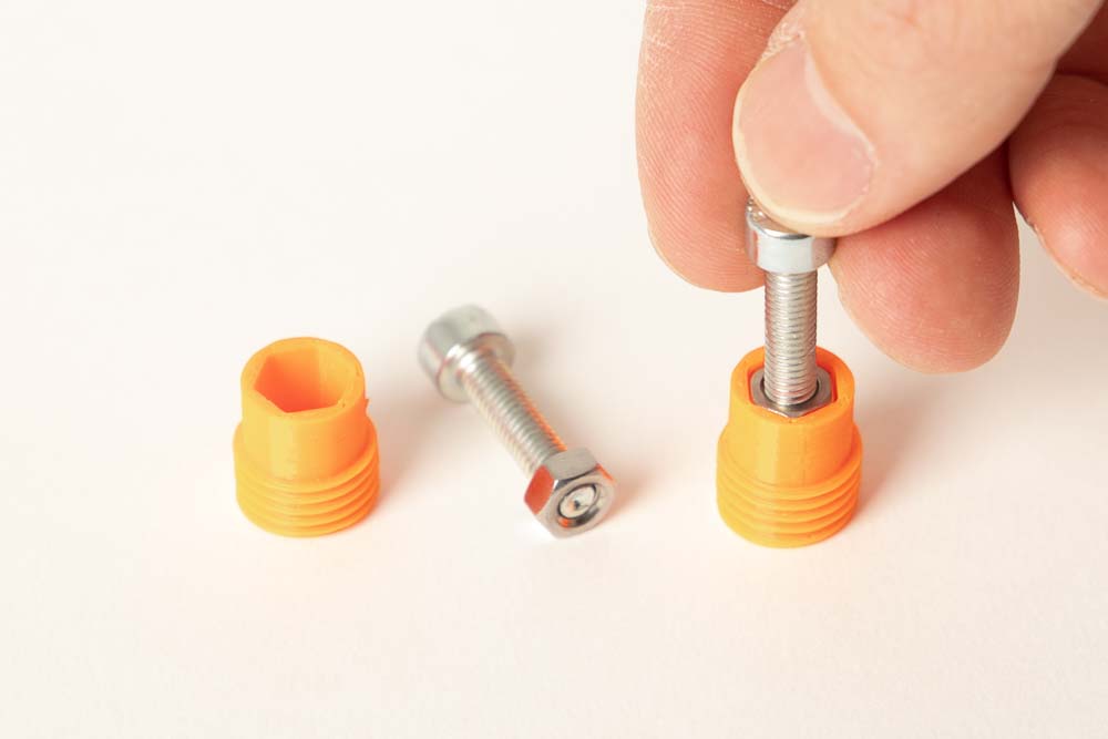 Inserting the M5 nuts into the 3D printed cap for the magnetic lock