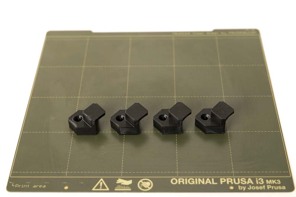 4 pieces of 3D printed weight brackets with a height of 17 mm in PETG filament black printed on a flexible PEI Flex plate of the 3D printer