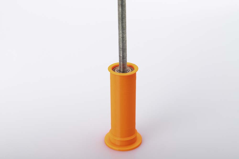M8 threaded rod sits slightly at an angle in the 3D printed wide pulley with inserted 608 ball bearings.