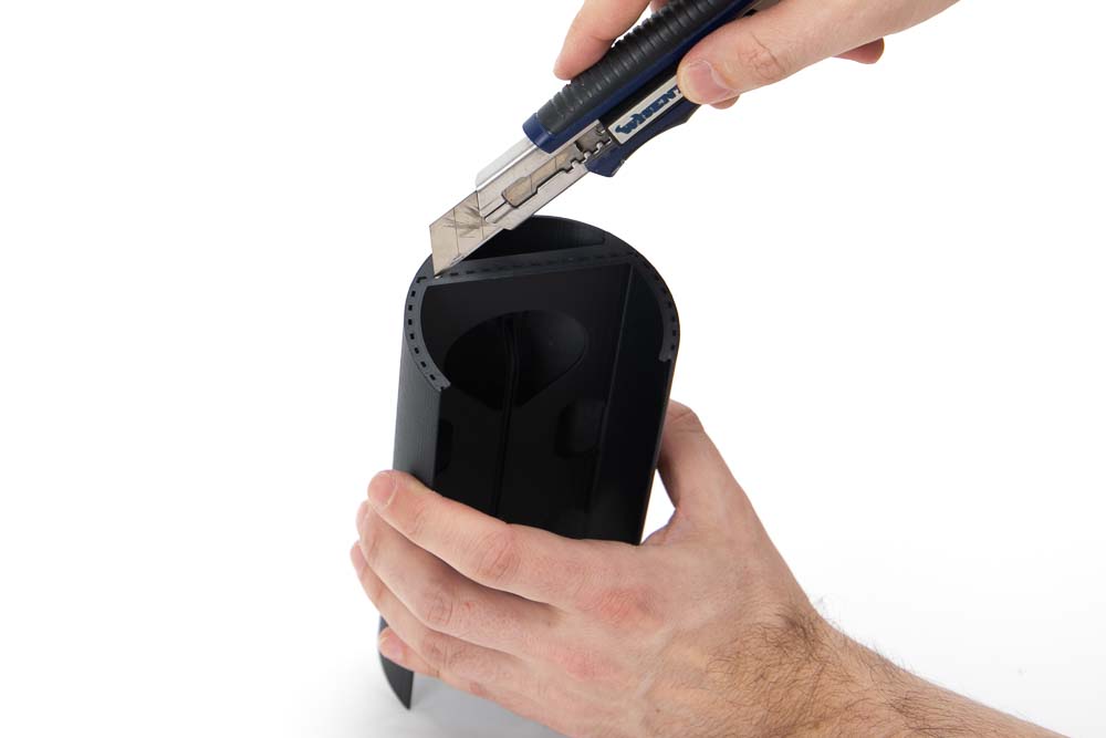 Support structures of a 3D printed inner part of the 3D printed pendant light are removed with a utility knife.