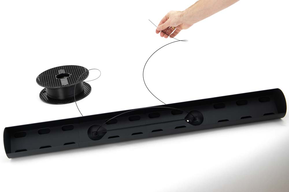 Filament is threaded into the 3D printing light body