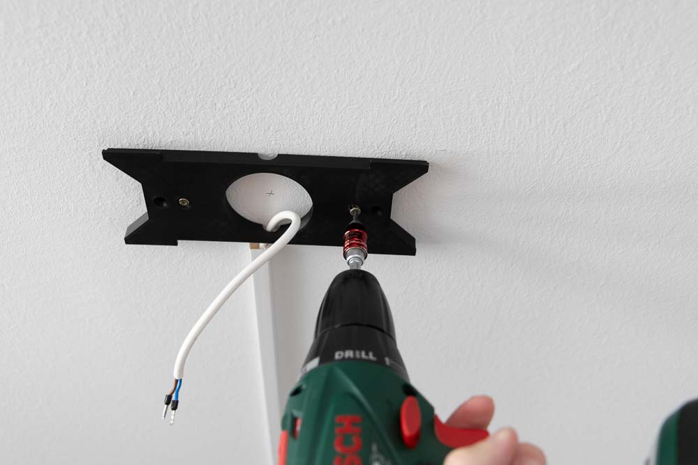 The 3D printed ceiling mount is screwed to the ceiling.