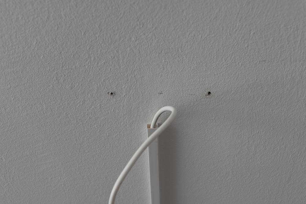 Two holes were drilled into the ceiling where the pendant light will later be installed.