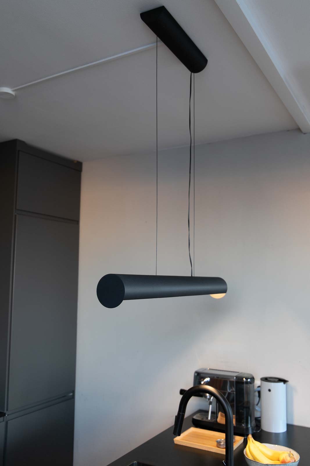 Image of a fully assembled 3D printed hanging lamp mounted above a kitchen island in the kitchen