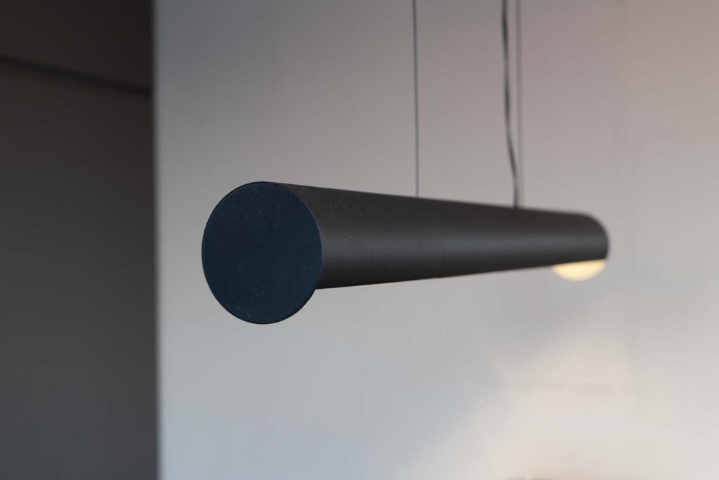 Close-up of the 3D printed suspending light showing only the cylindrical light fixture
