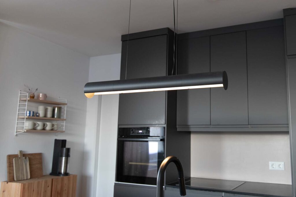 3D Print Design Pendant Light mounted above a kitchen island in a kitchen in the background